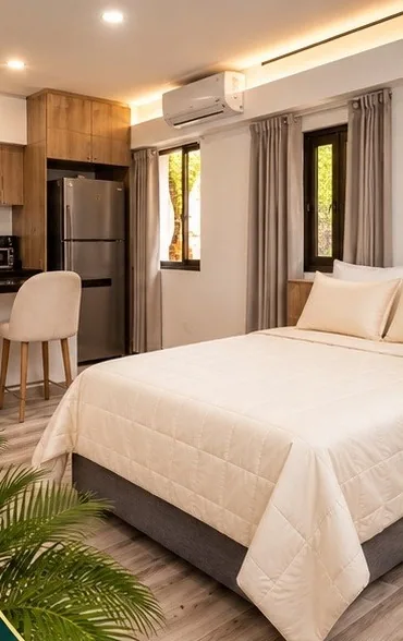 Dormitorio de la Suite Studio con cama de sábanas blancas